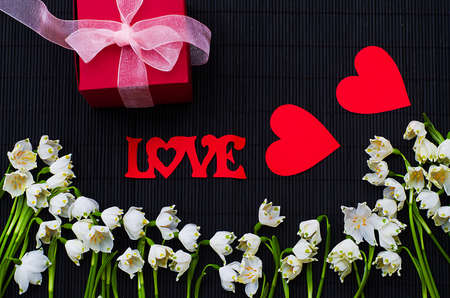Bouquet of snowdrops in springtime with a gift on holiday