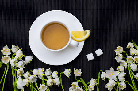 Spring breakfast hot tea and a bouquet of snowdrops for a good moodの写真素材