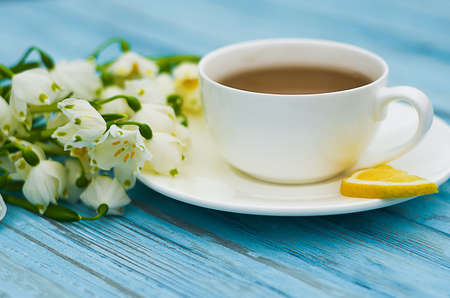 Spring breakfast hot tea and a bouquet of snowdrops for a good mood