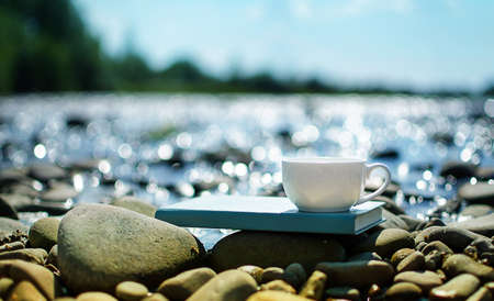 A cup of tea, coffee, cacao in the water on a stork on a stony day on a summer dayの写真素材
