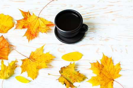 Autumn leaves around coffee pots in the open air