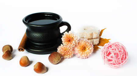 Hot tea in a pot on a limited white background with cookies and decorationsの写真素材