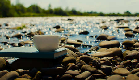 A cup of tea, coffee, cacao in the water on a stork on a stony day on a summer dayの写真素材