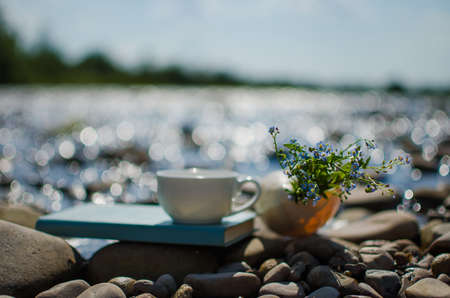 A cup of tea, coffee, cacao in the water on a stork on a stony day on a summer dayの写真素材
