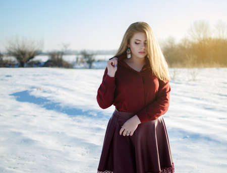 Young smiling girl in the winter in the open air