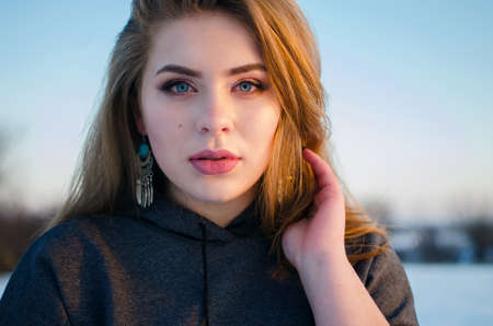 Young smiling girl in the winter in the open airの写真素材