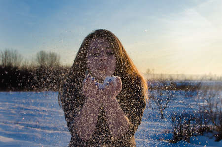 Young smiling girl in the winter in the open airの写真素材