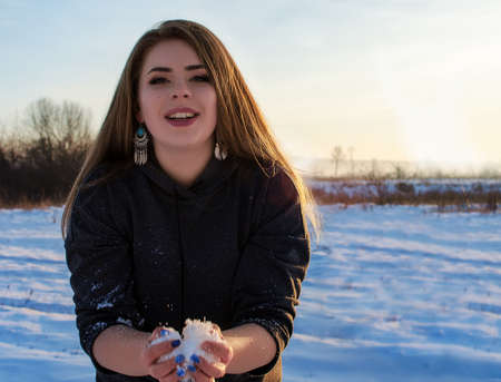 Young smiling girl in the winter in the open airの写真素材