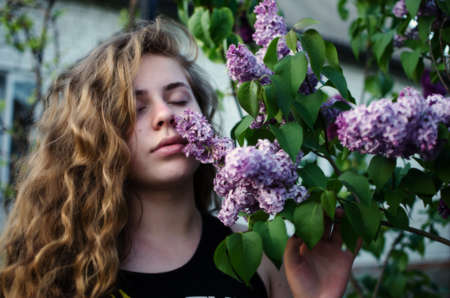 Beautiful happy girl in the spring in the fresh air in a good moodの写真素材