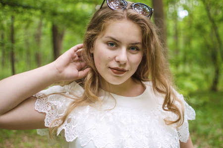 Beautiful happy girl in the spring in the fresh air in a good moodの写真素材