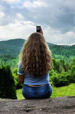 Young smiling girl with curly hair on the background