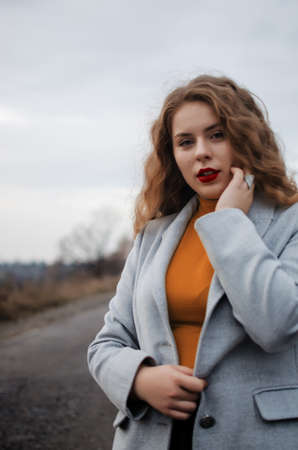 Young smiling girl with curly hair on the backgroundの写真素材