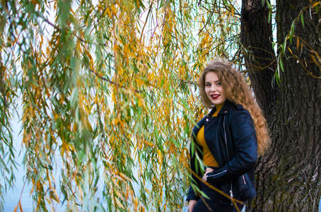 Young smiling girl with curly hair on the backgroundの写真素材