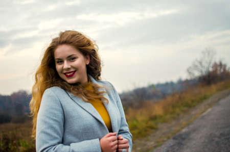 Young smiling girl with curly hair on the backgroundの写真素材