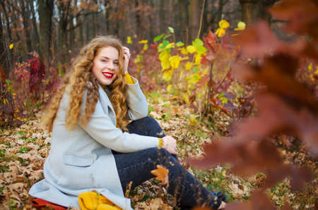 Young smiling girl with curly hair on the background