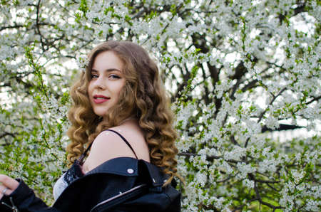 Beautiful happy girl in the spring in the fresh air in a good moodの写真素材