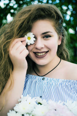 Beautiful happy girl in the spring in the fresh air in a good moodの写真素材