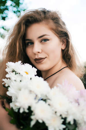 Beautiful happy girl in the spring in the fresh air in a good moodの写真素材