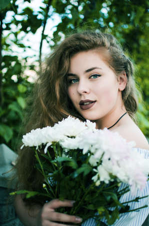 Beautiful happy girl in the spring in the fresh air in a good moodの写真素材