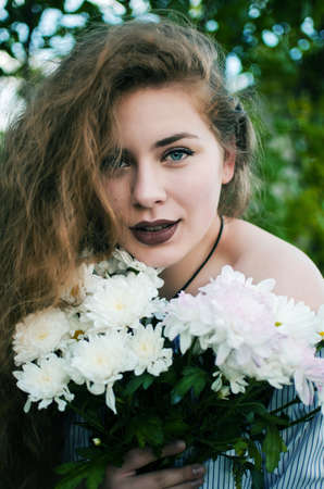 Beautiful happy girl in the spring in the fresh air in a good moodの写真素材