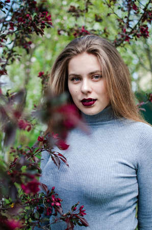 Happy girl with long hair walking in the spring outdoorsの写真素材