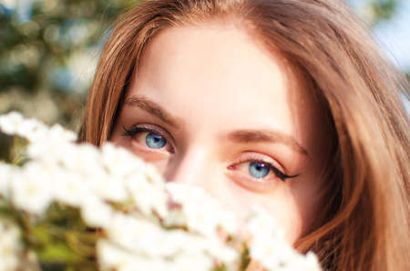 Happy girl with long hair walking in the spring outdoorsの写真素材