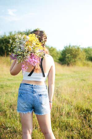 Happy girl with long hair walking in the spring outdoorsの写真素材
