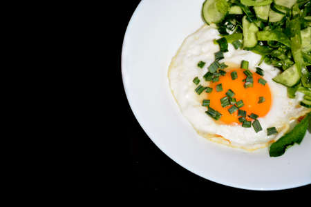 Appetizing scrambled eggs with cabbage salad on a white plateの写真素材