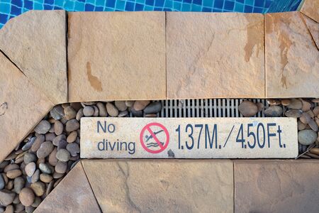 no diving sign at swimming pool side. show how deepness is in meter and foot measure.の写真素材
