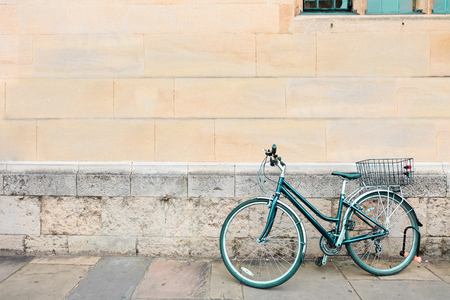 green bicycle parked, lean on old brick concrete grunge wall and window. vintage color, hipster style, urban lifestyle.の写真素材