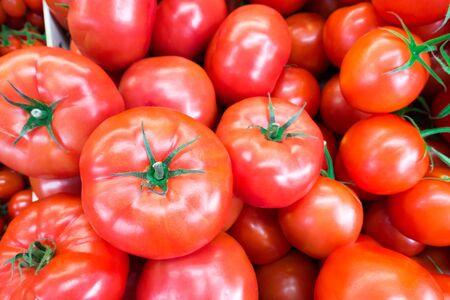 Close up of fresh, juicy, ripe tomatoes pile. lycopene and antioxidant in fruit nutrition good for health and skin. flat layの写真素材