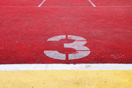   Number 3 on the start of a running old track                  の写真素材