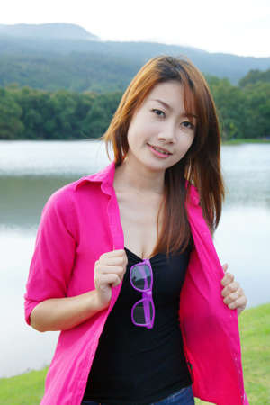 Asian student sitting at outdoors, studying and writing                  の写真素材