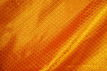 Golden satin, silk, waves. Yellow background                    の写真素材