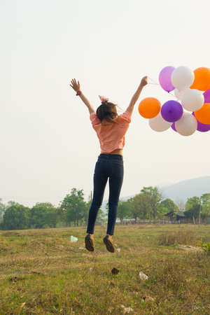 a happy woman holding balloonsの写真素材