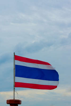 Image of waving Thai flag of Thailand with blue sky background 
