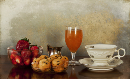 A delicious morning meal  a cup of strong coffee, milk, an orange juice glass, little chocolate chip...
