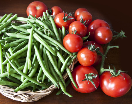 Food preparation on the kitchen table, green beans and ripe cherry tomatoesの写真素材