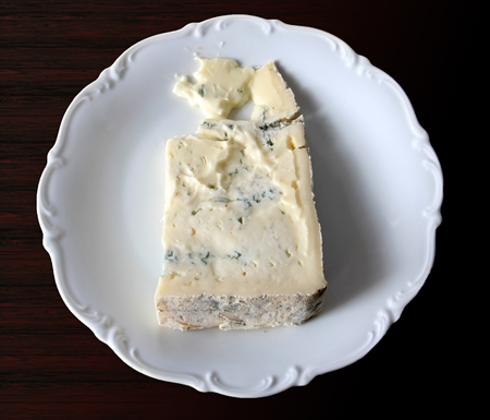 A delicious piece of gorgonzola cheese ready on the tableの写真素材