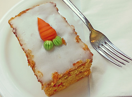 Slice of delicious carrot cake sugar coated and top decorationの写真素材