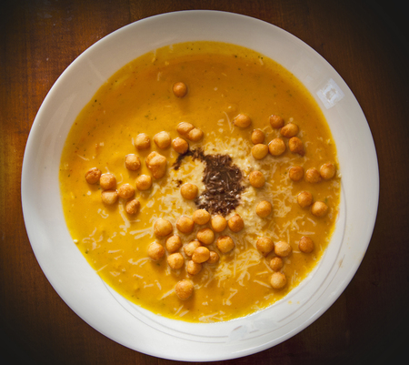 Hokkaido pumpkin soup with a hint of balsamic vinegar, parmesan and back peasの写真素材