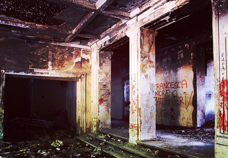 Urban structure ruined and abandoned with debris and graffiti, with retro  desaturated colors.