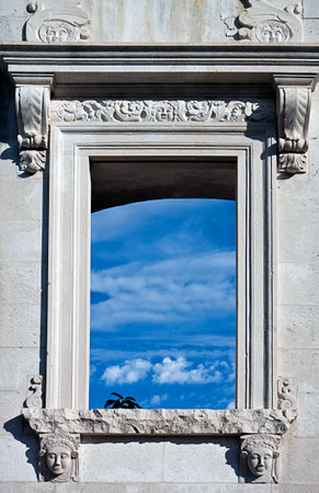 Ancient Roman ruin in Zadar, Croatia. Detail of decorated window and white stone wallのeditorial素材