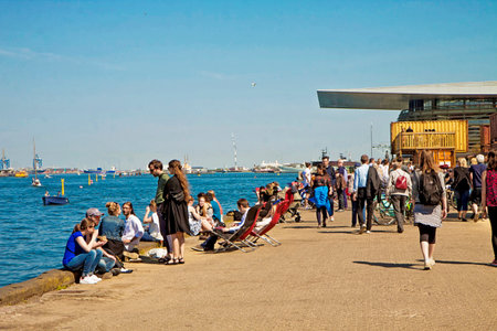 Copenhagen - people enjoy the beautiful weekend weather on the waterfront of Trangravsvej, eating outside the street food  market of Paper Islandのeditorial素材
