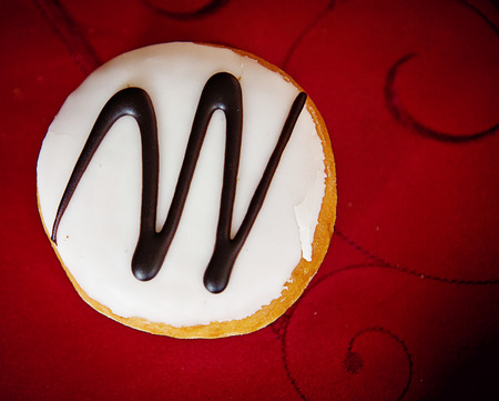 Doughnut with glazed cream and chocolate decoration
