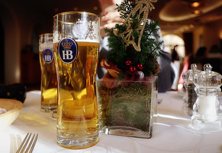 holiday decorated table and two glass of Bavarian HB famous beerのeditorial素材