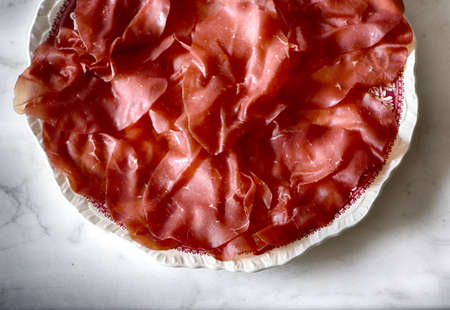 Italian bresaola: dry salted beef raw ham seasoned and tender, originated in Valtellina a valley in the Alpsの写真素材