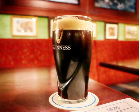 Guinnes beer glass served cold at Irish pub