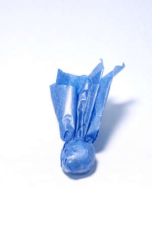 Candy in blue wrapper isolated on white