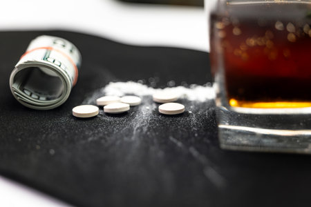 This stock images i about Drugs pills dollar and alcohol in glass addictの写真素材
